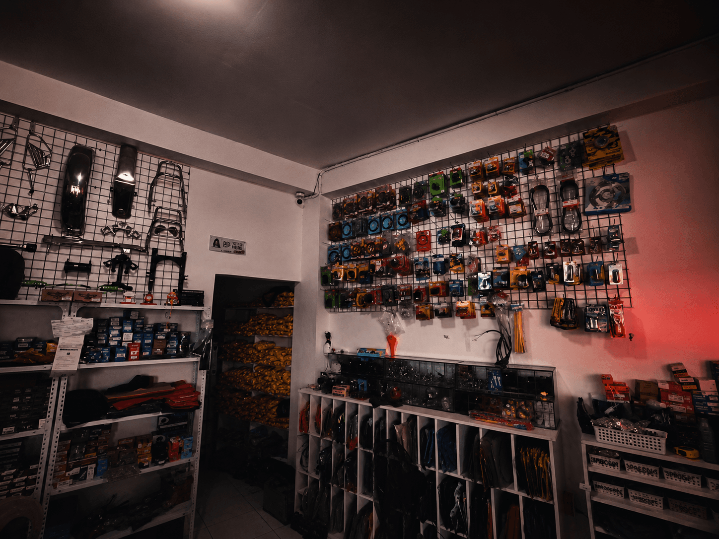 Pegboard wall lined with packaged motorcycle parts and accessories